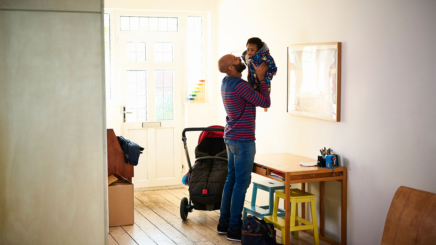 A father and child in a foyer