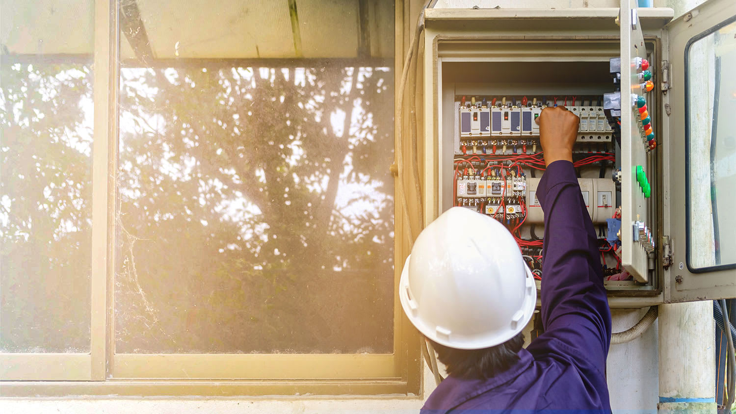 Electrician at electrical panel