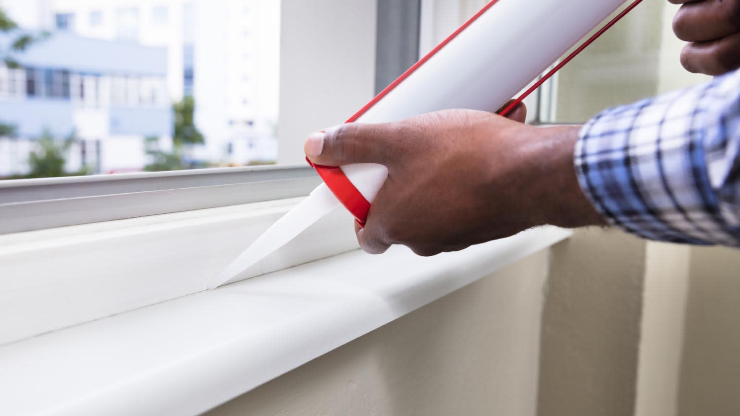 A worker applying silicone sealant