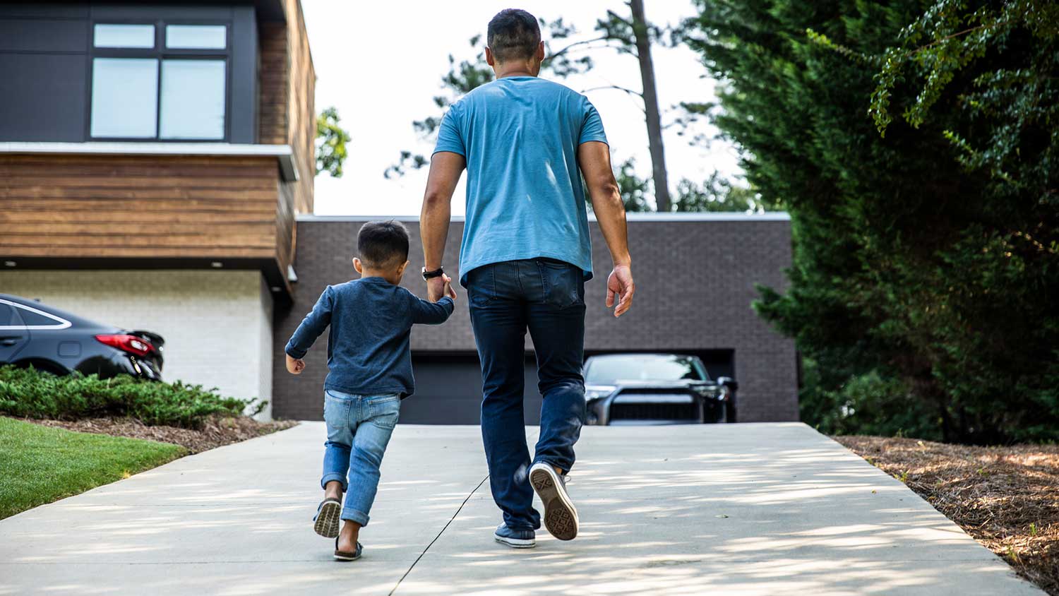 Father and son walking on the driveway