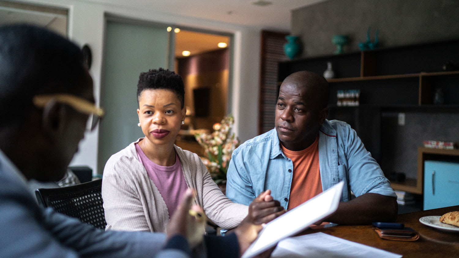 A couple discussing in-person with a moving company representative