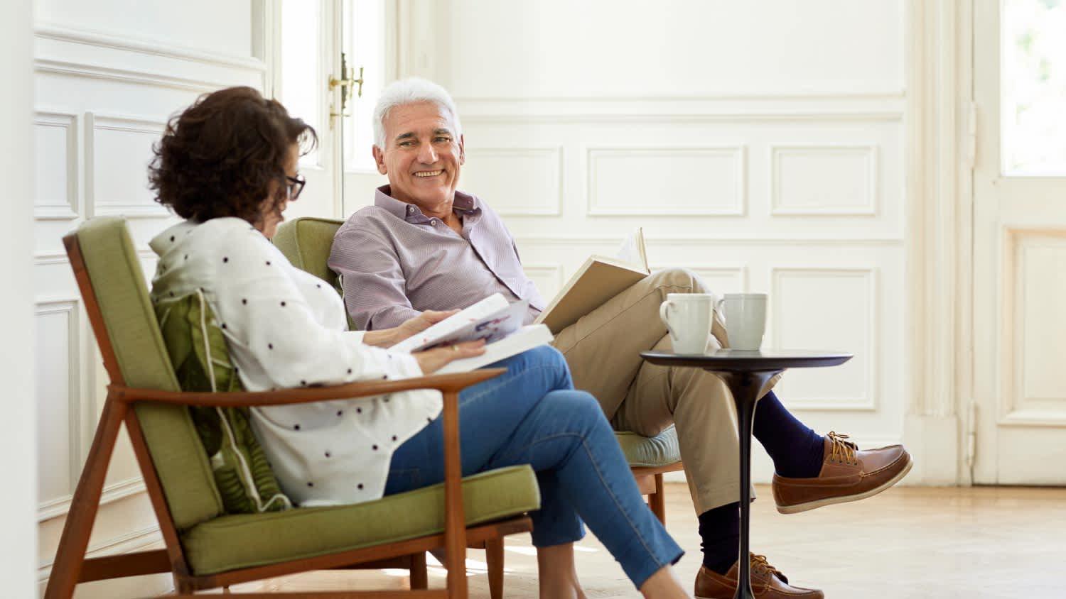 A senior man and woman relaxing in apartment