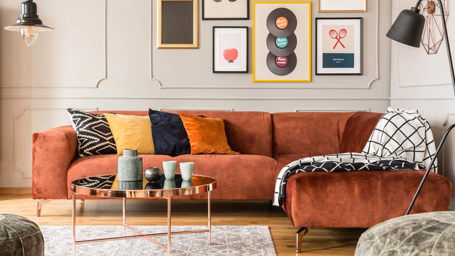 An eclectic living room with a velvet corner sofa