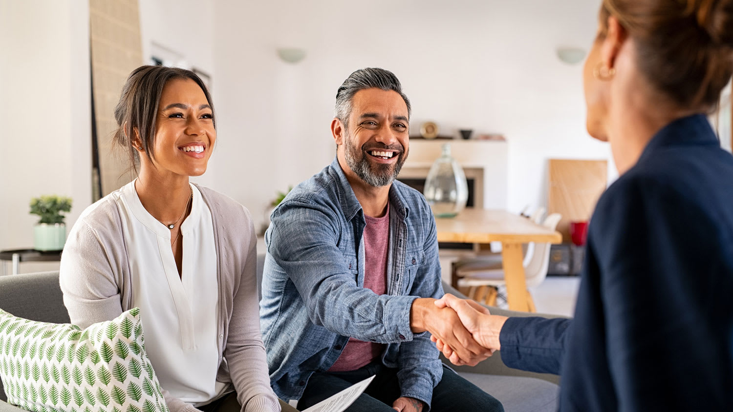 Couple shaking hands with real estate agent