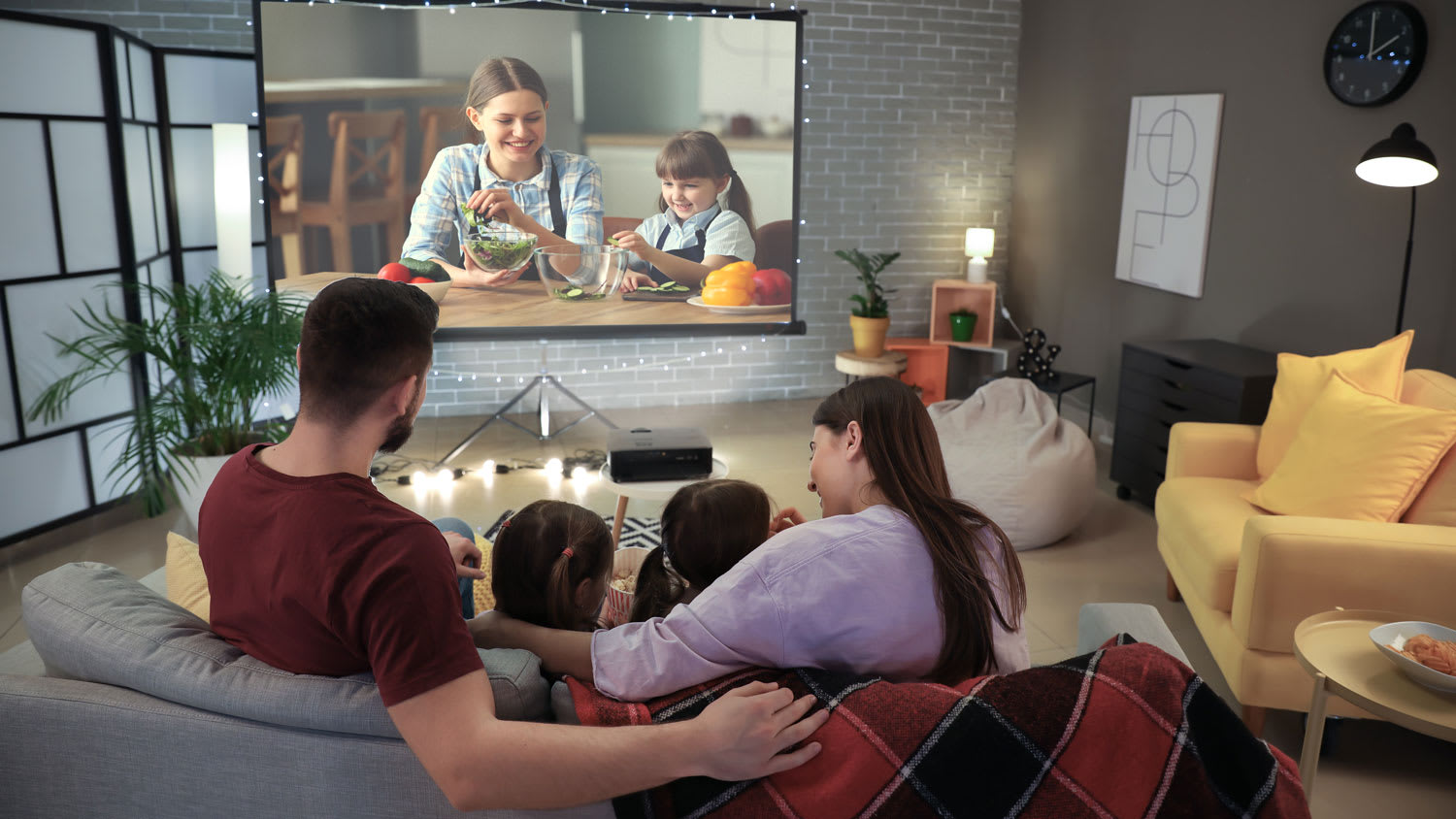 A young family watching a movie at home