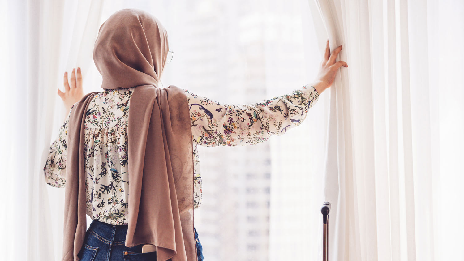 A woman admiring a view from a window