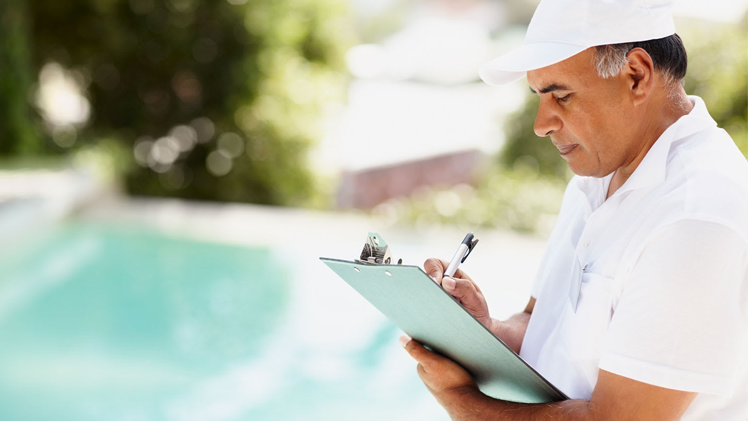 A man inspects a swimming pool
