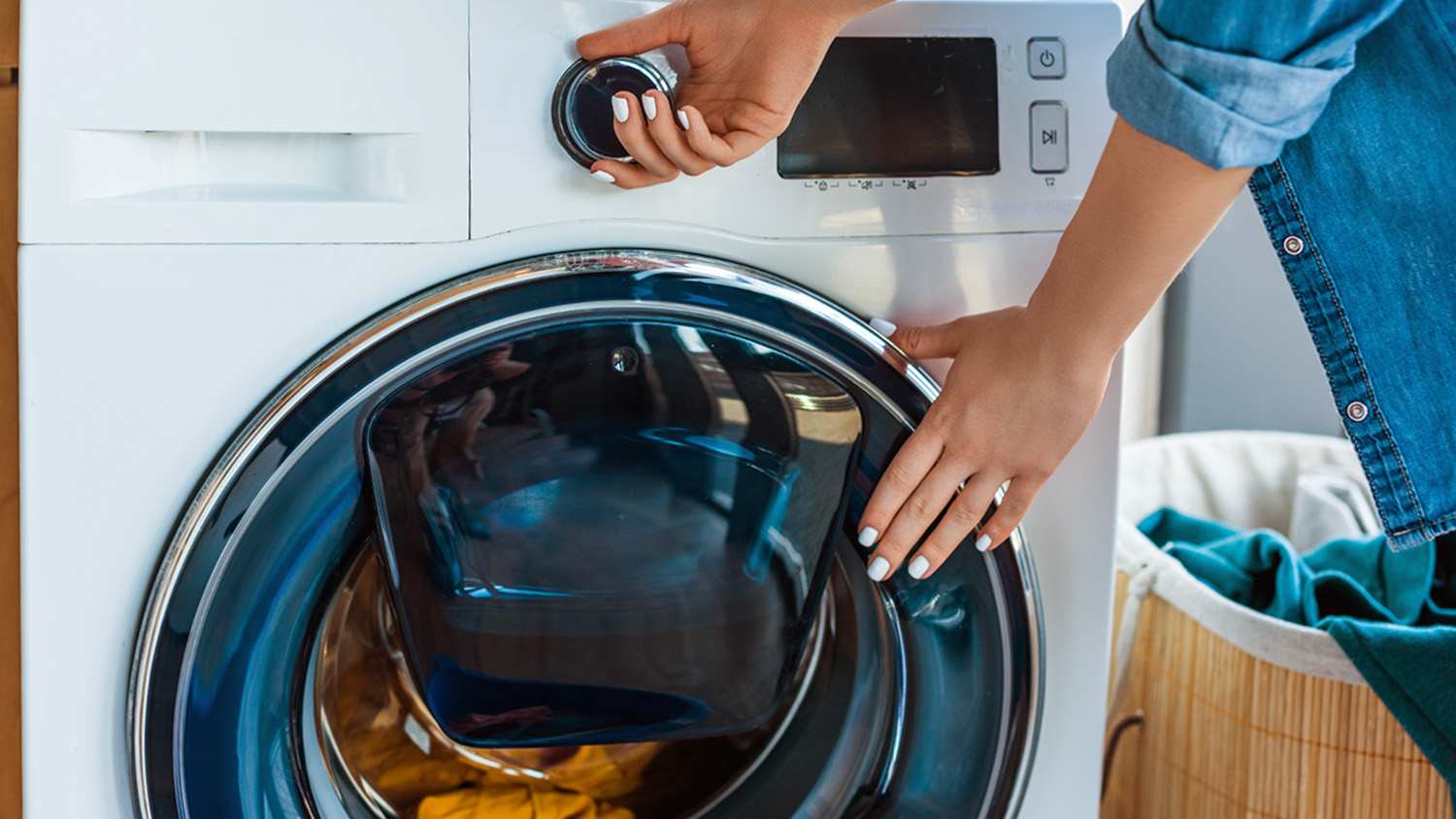 woman turning on washing machine