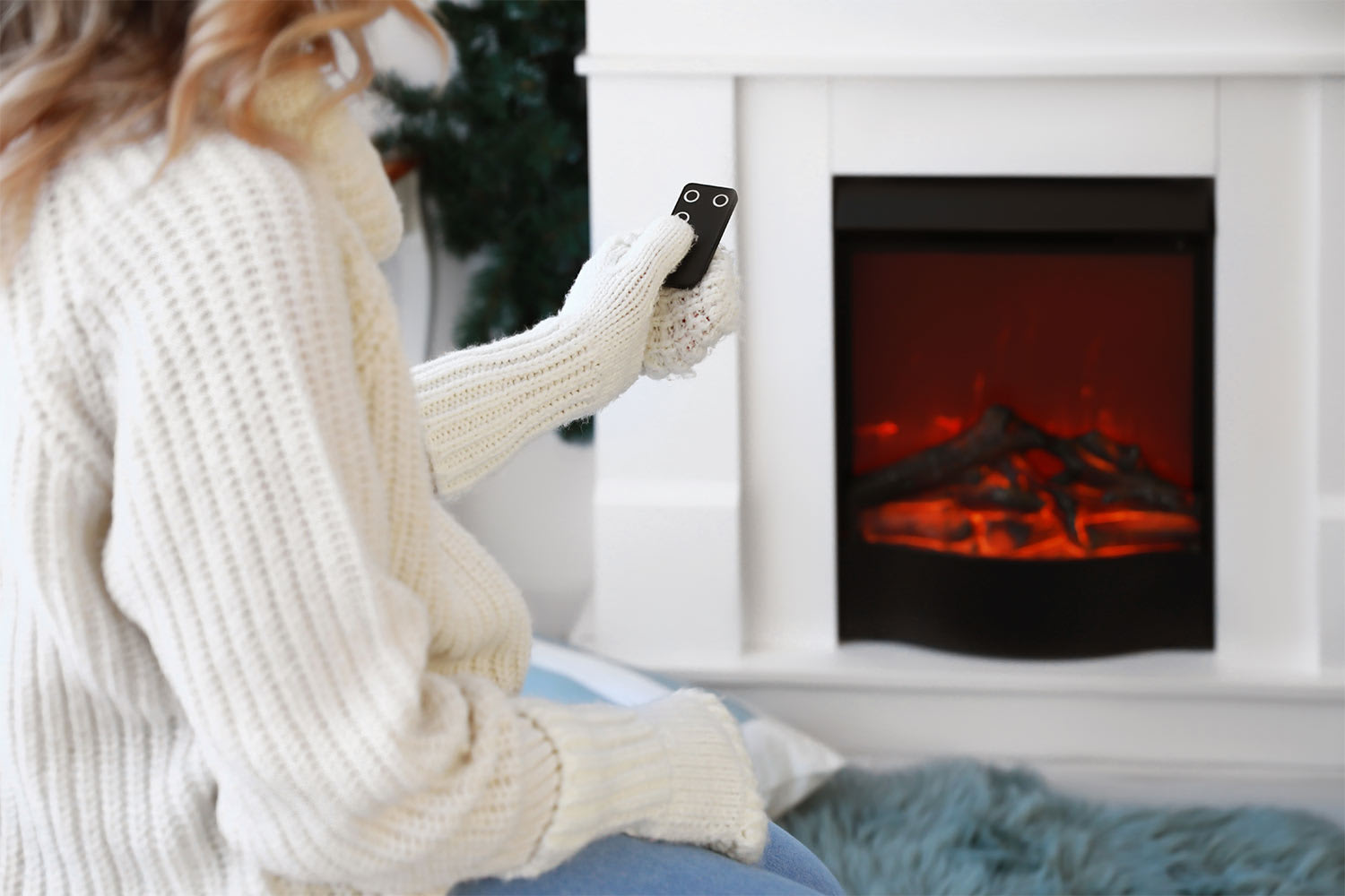 woman controlling electric fireplace