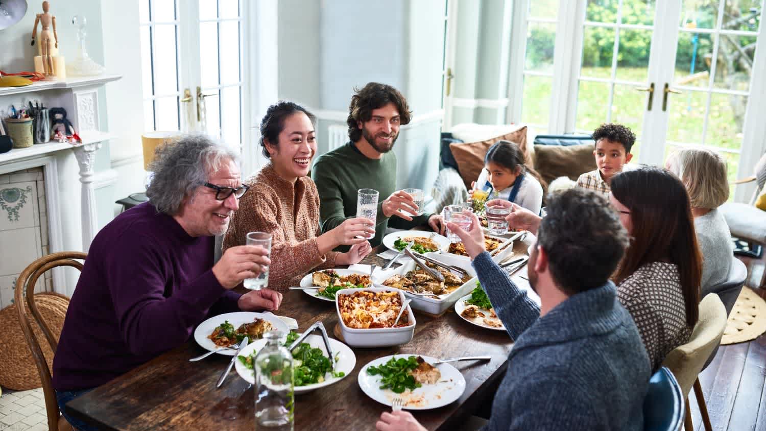 Extended family toasting drinks at lunch