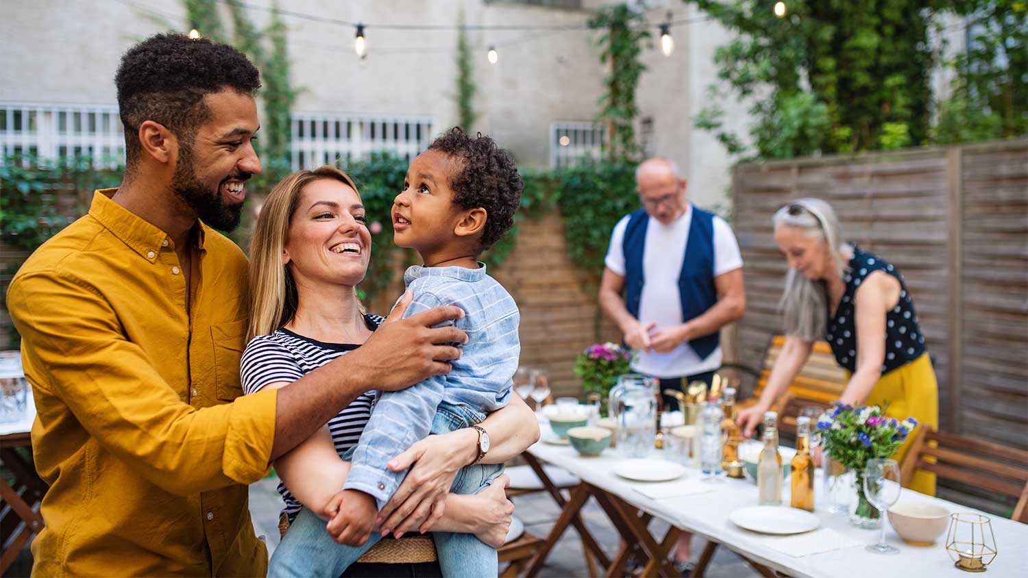 Family setting up backyard party