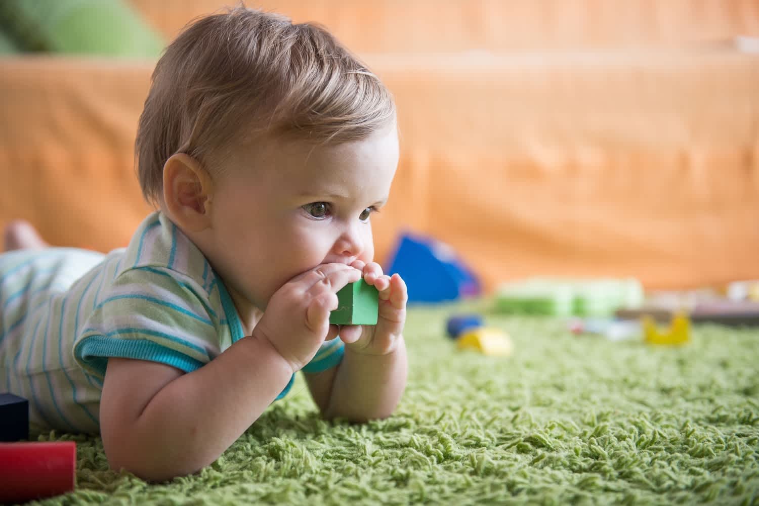 crawling baby chewing on time