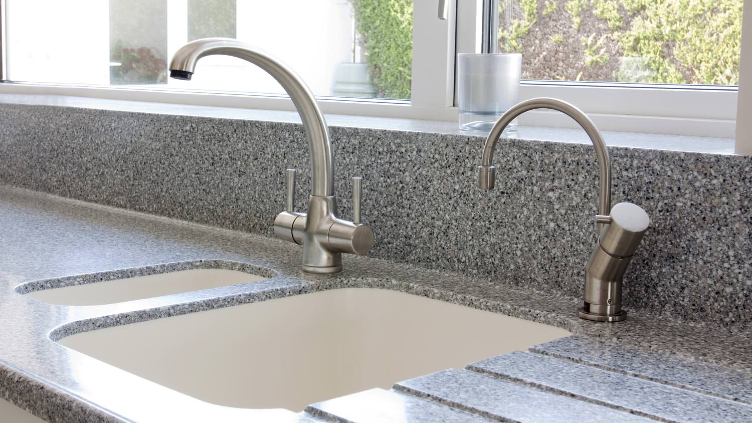 Integrated white sink in gray speckled countertop