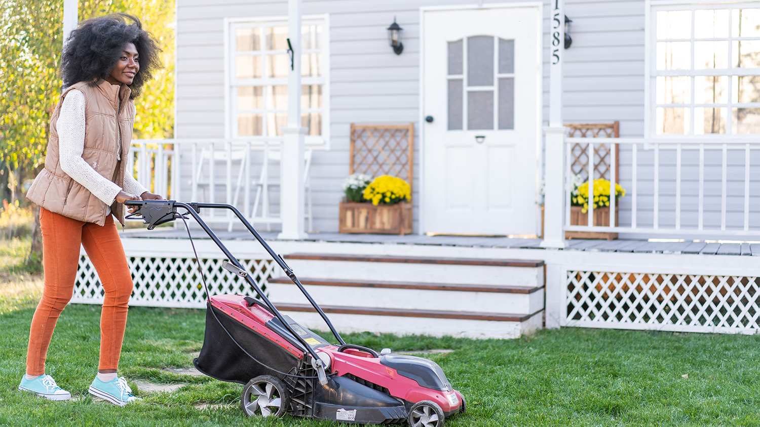 woman mowing her front lawn