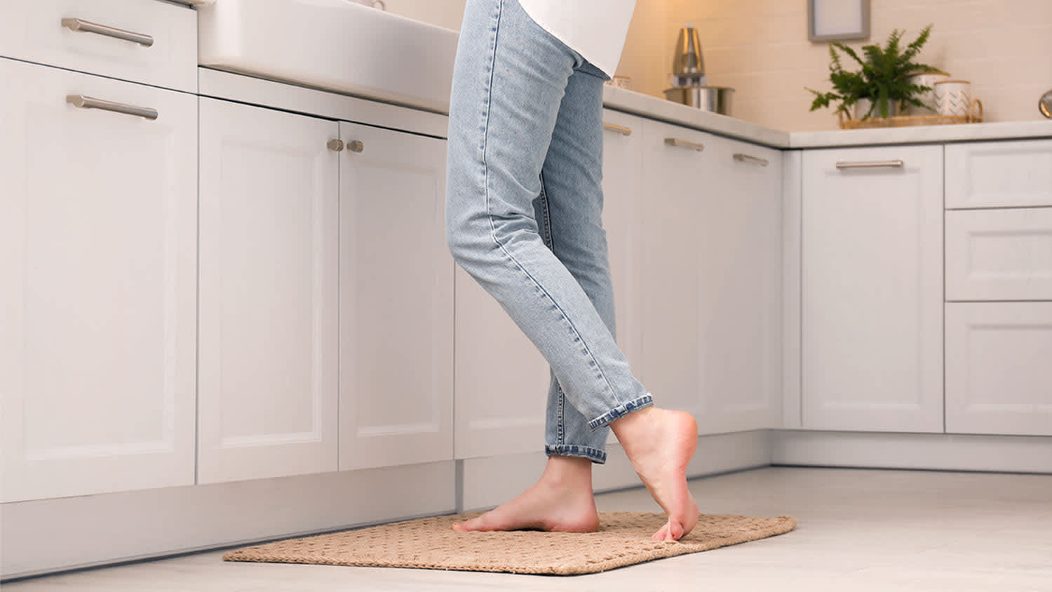 woman standing on kitchen rug in front of sink