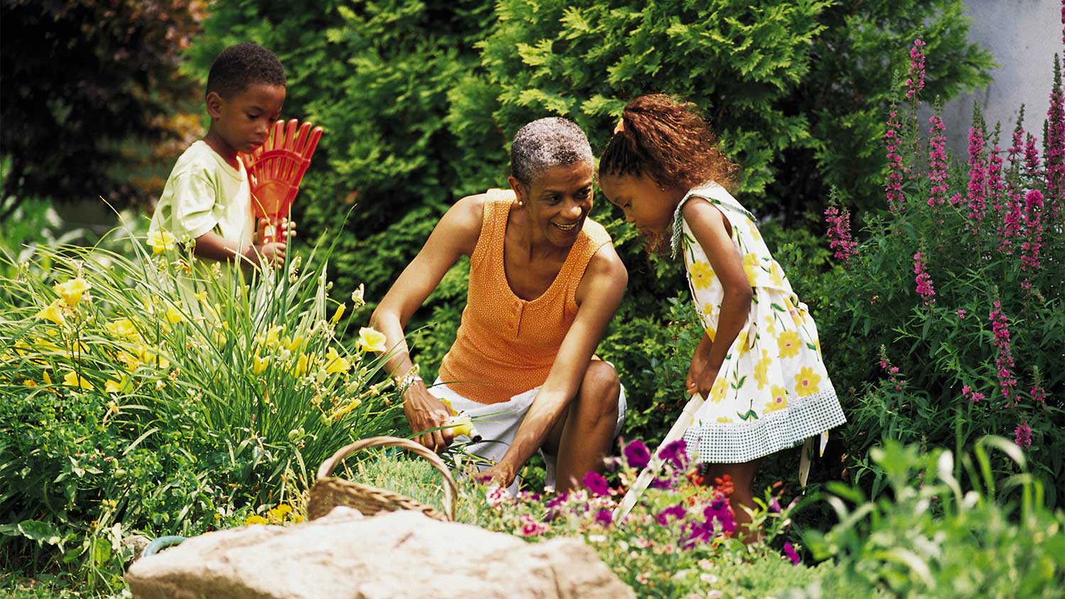 Grandmother and grandchildren in flower garden