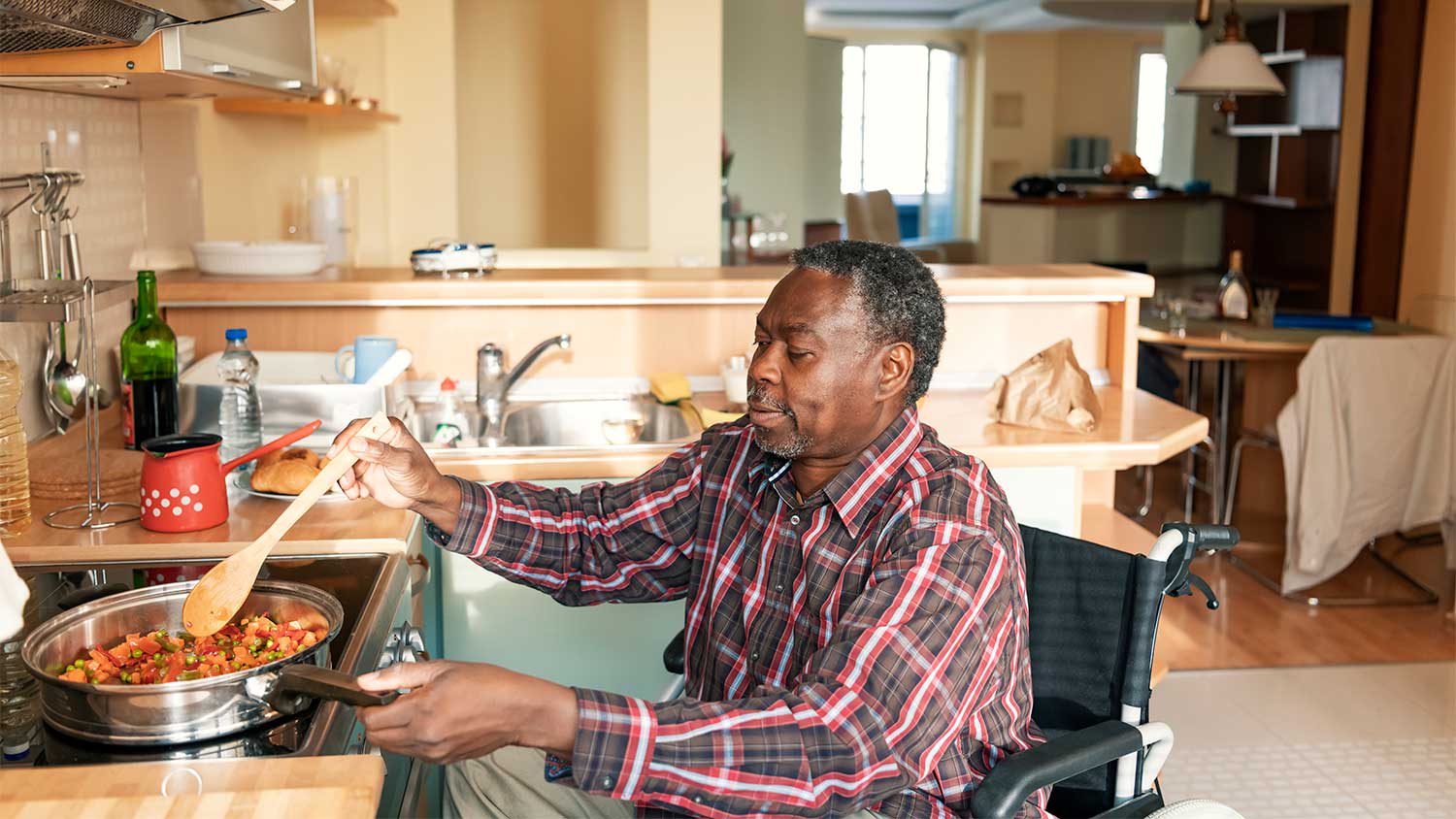Man in wheelchair preparing meal