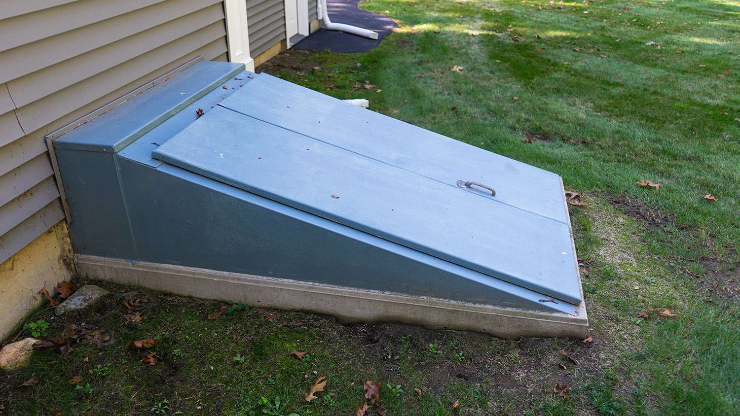 blue storm cellar doors in backyard