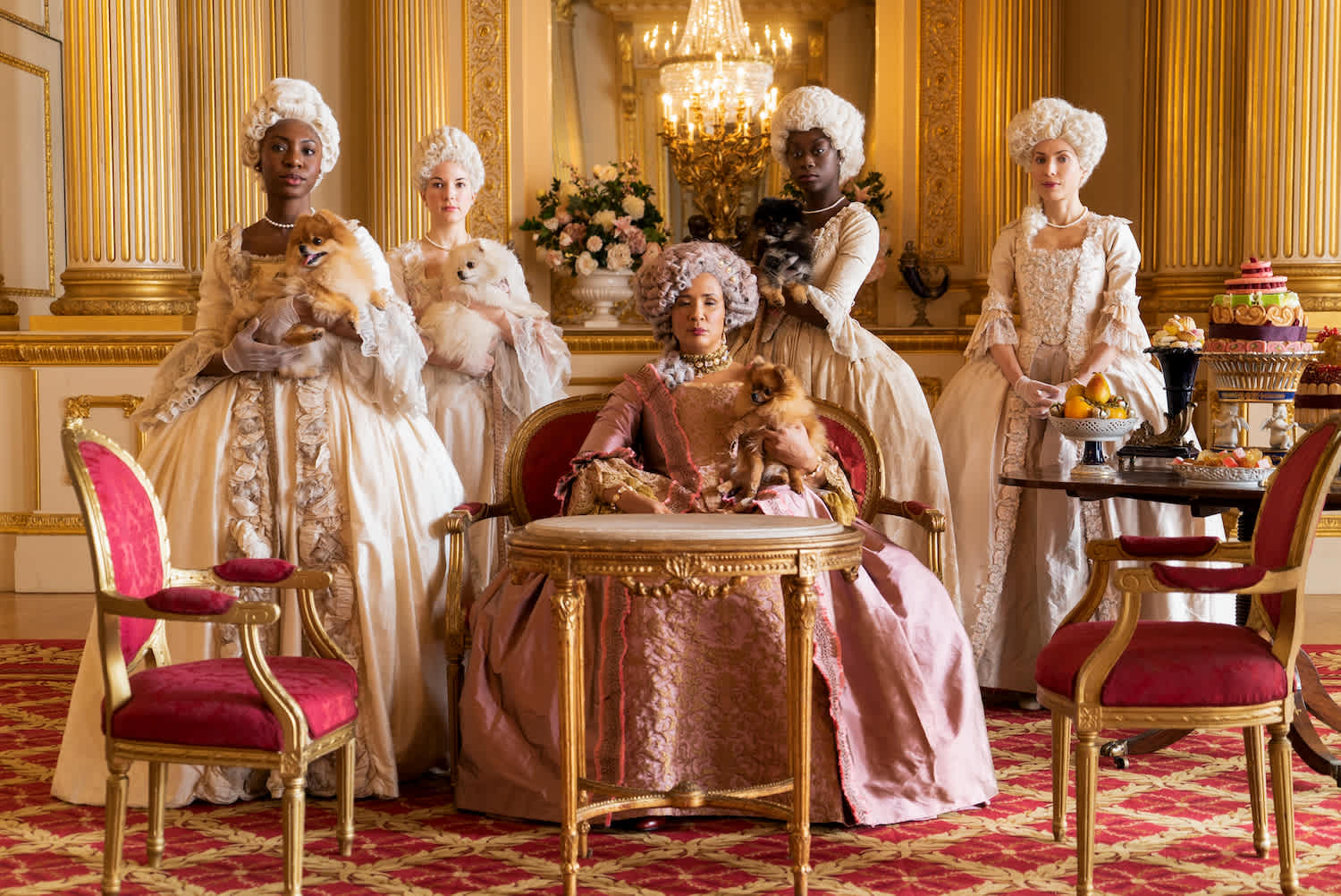 Bridgerton women in period costume standing in ornately decorated room
