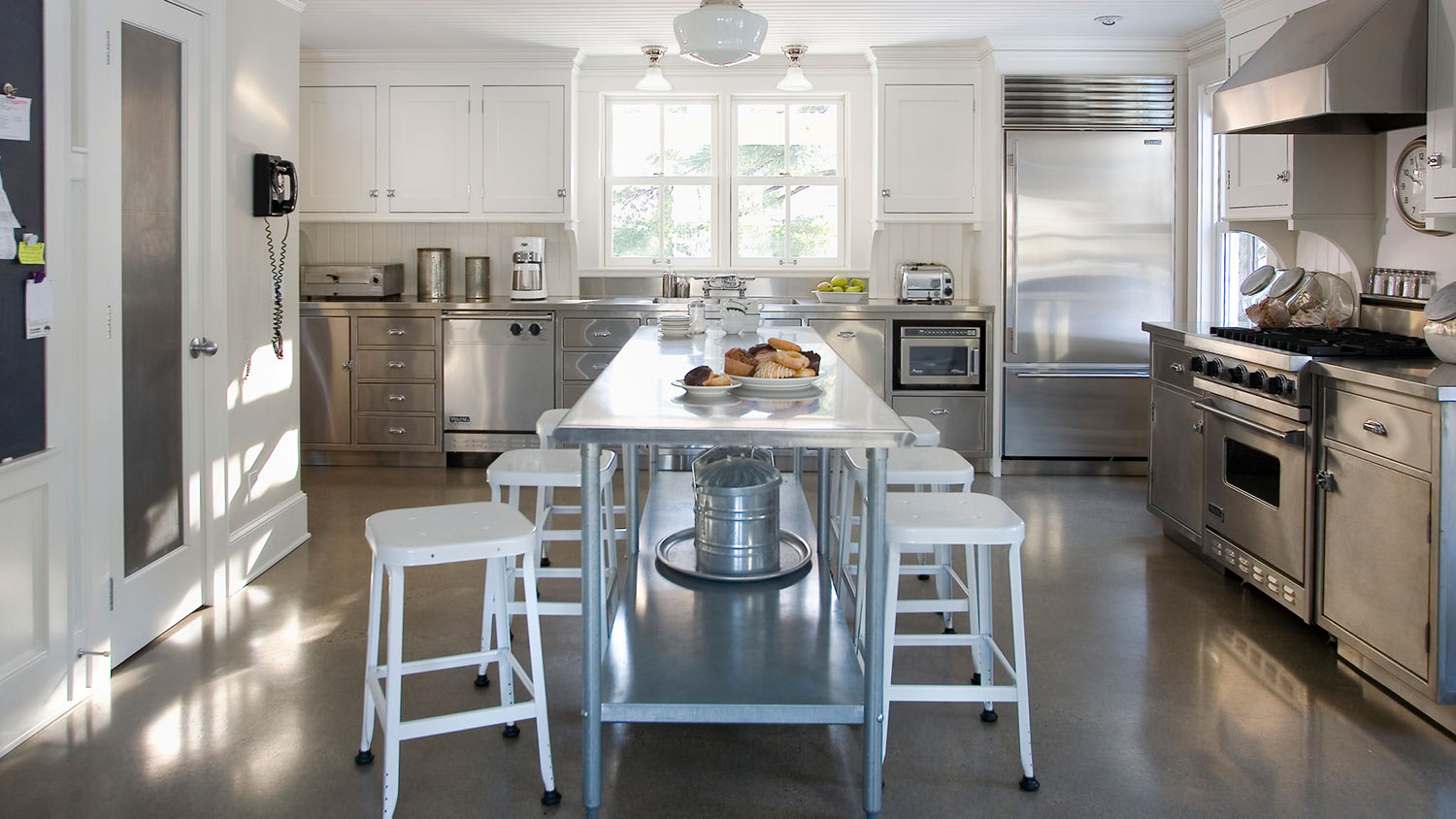 Beautiful modern kitchen with chairs at bar