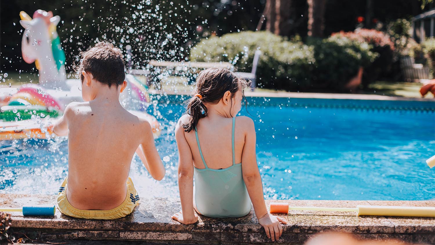 Kids splashing on side of pool