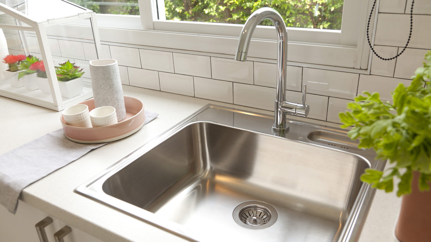 Single basin stainless steel sink in small kitchen