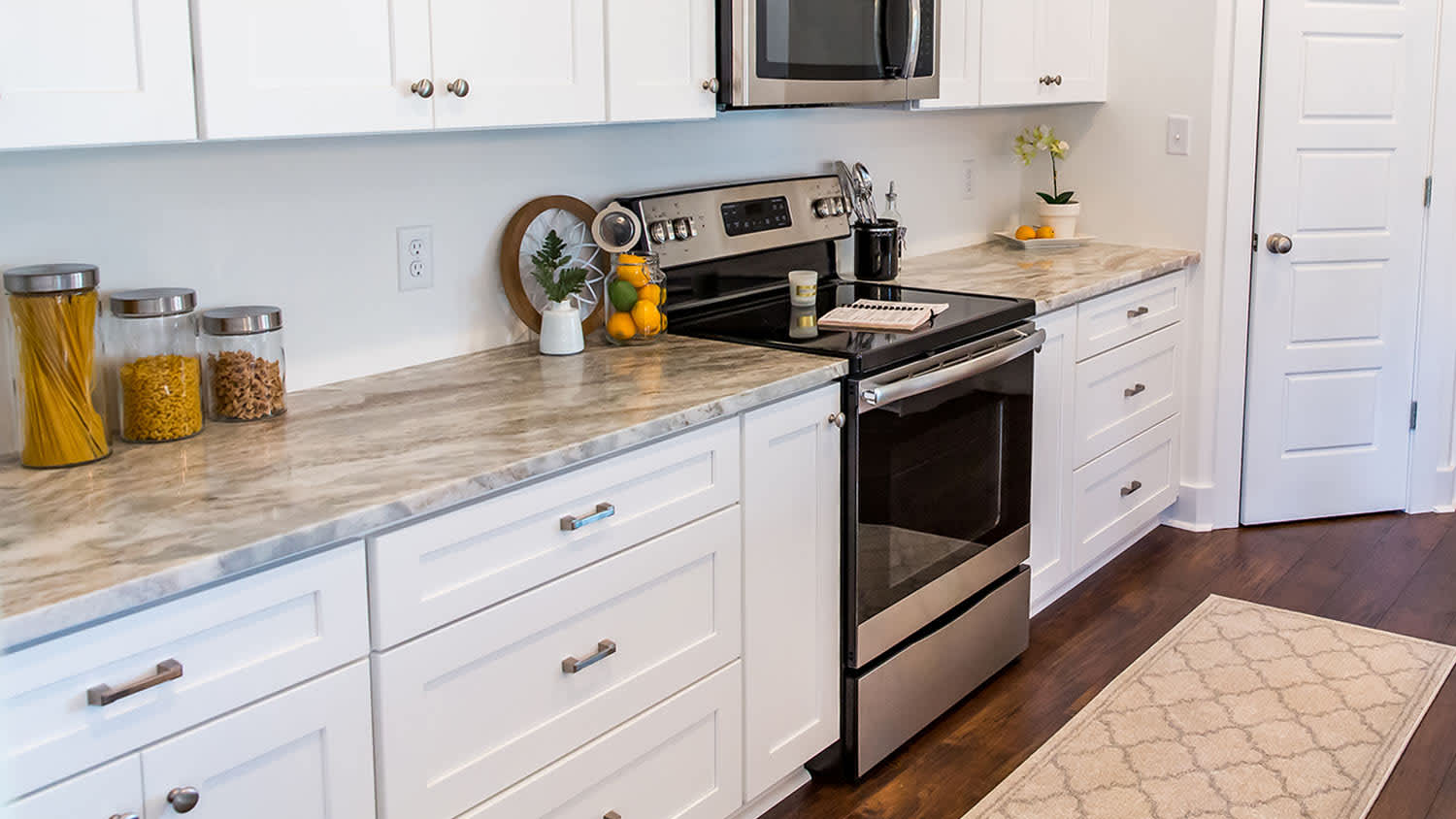 white cabinet kitchen with rug