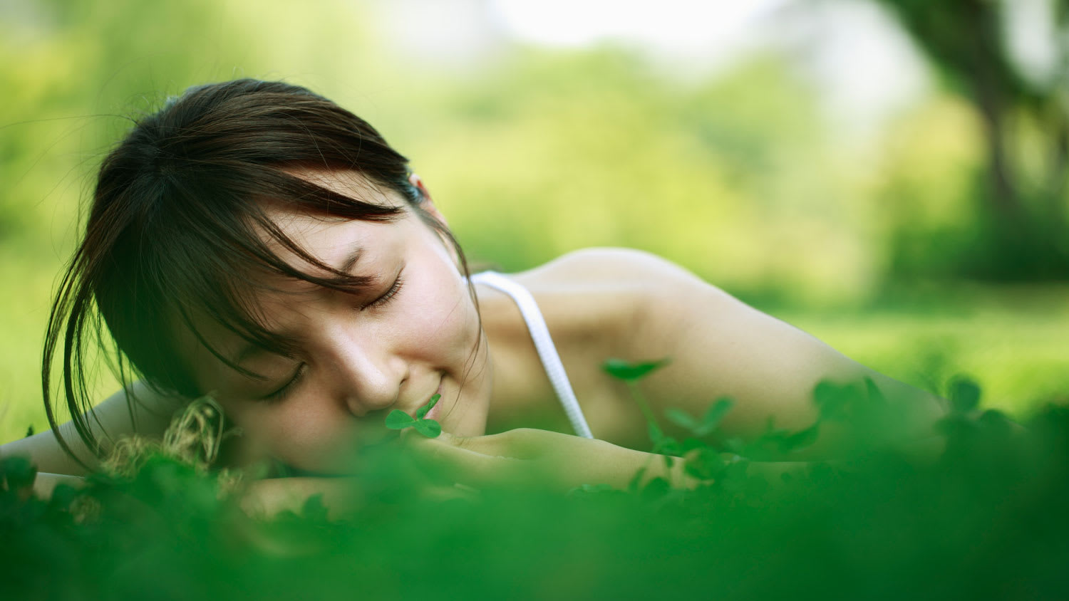 young woman lying in the grass, healthy lifestyle