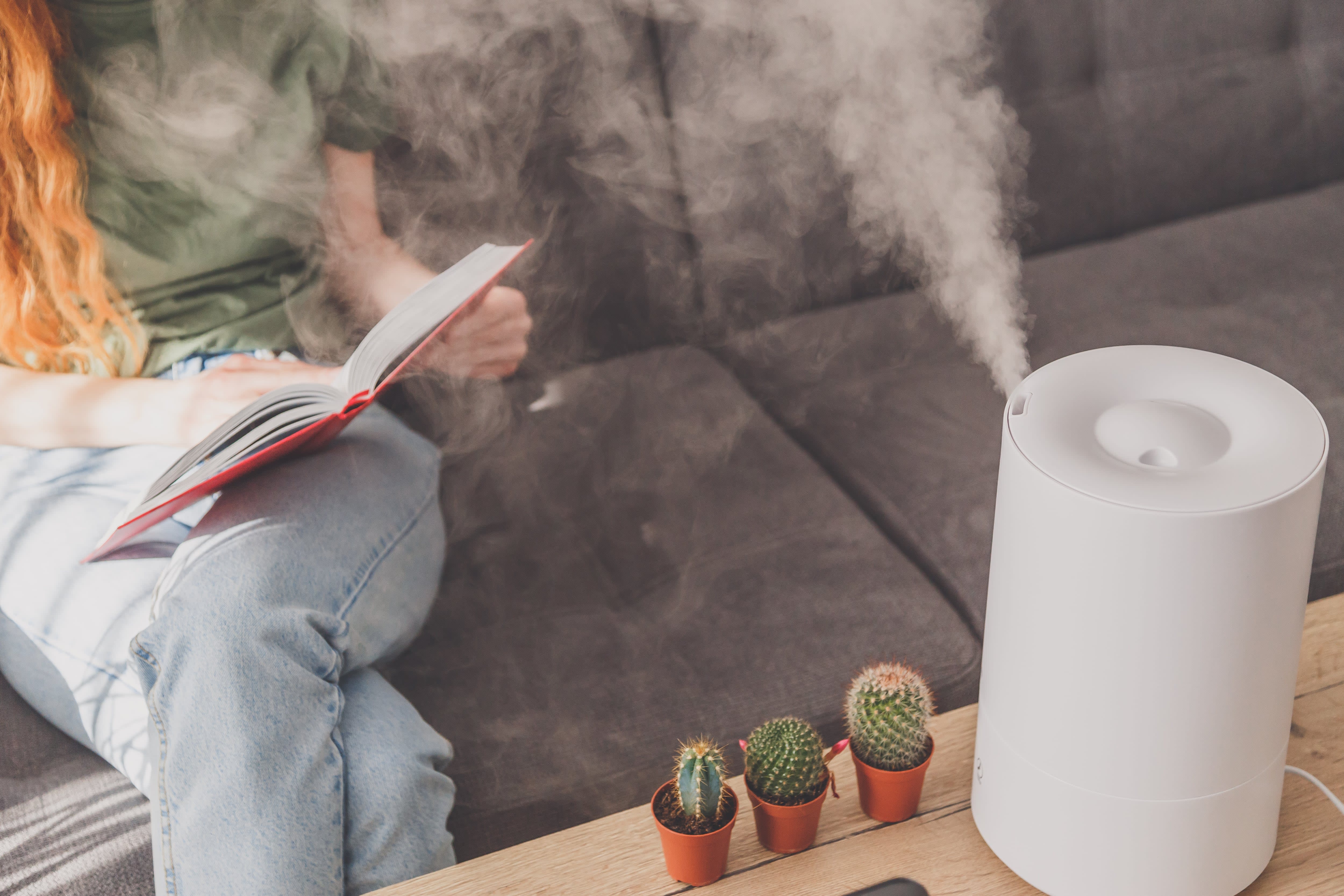 Woman reading while using humidifier