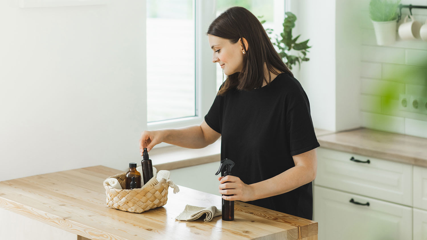 Woman putting cleaning products in a basket