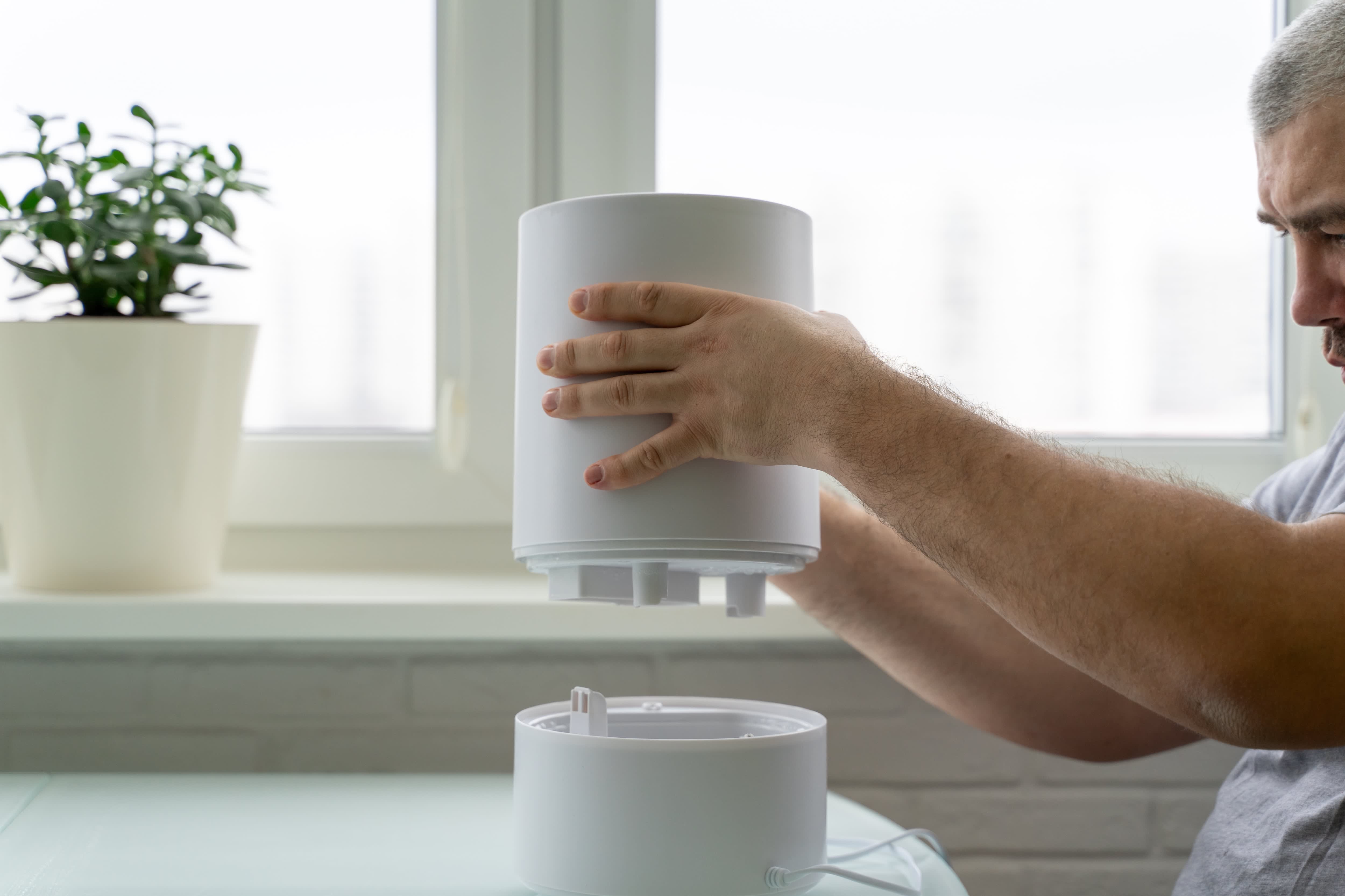 Man reassembling humidifier