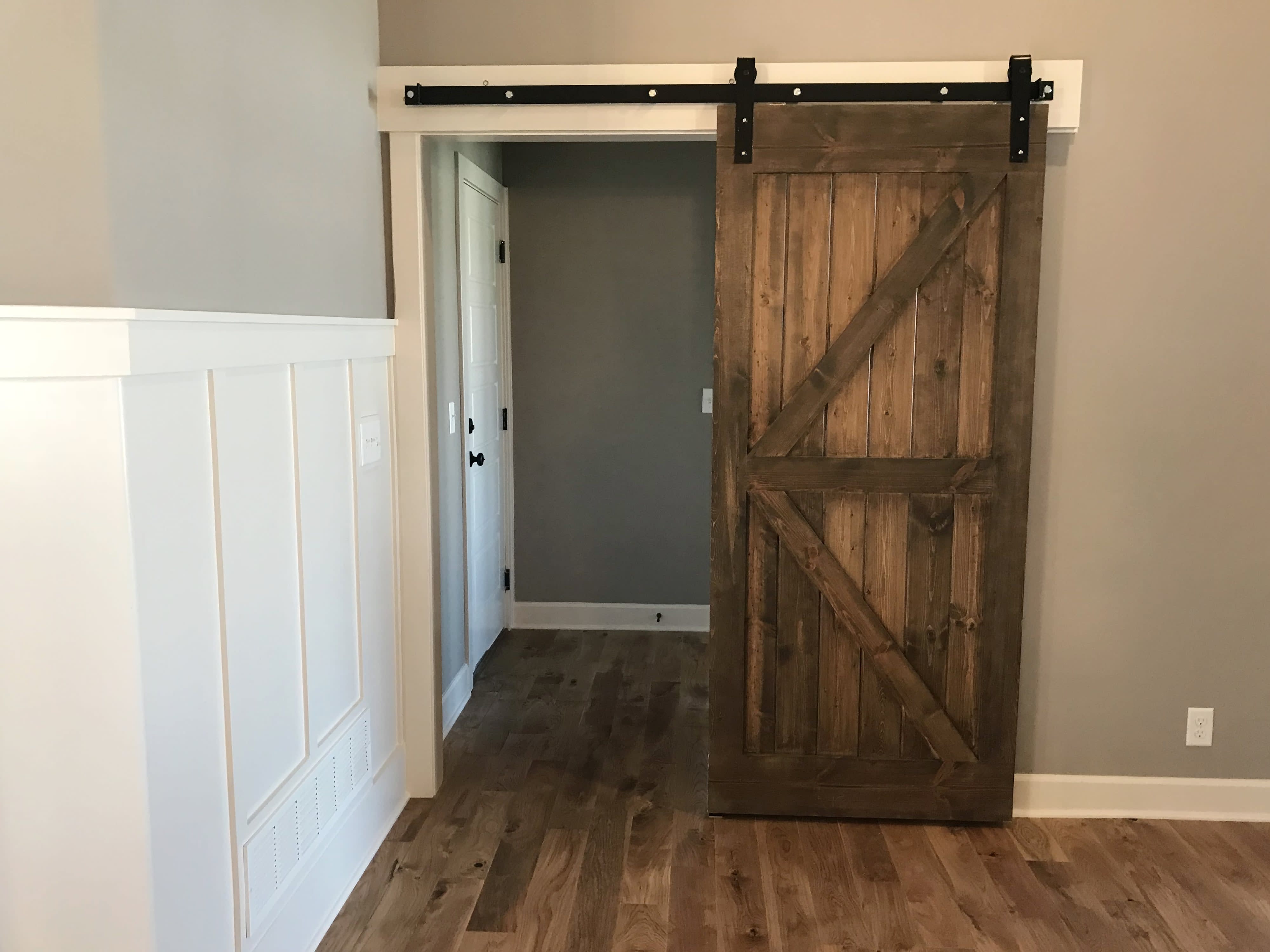 Rustic sliding barn doors leading to a closet