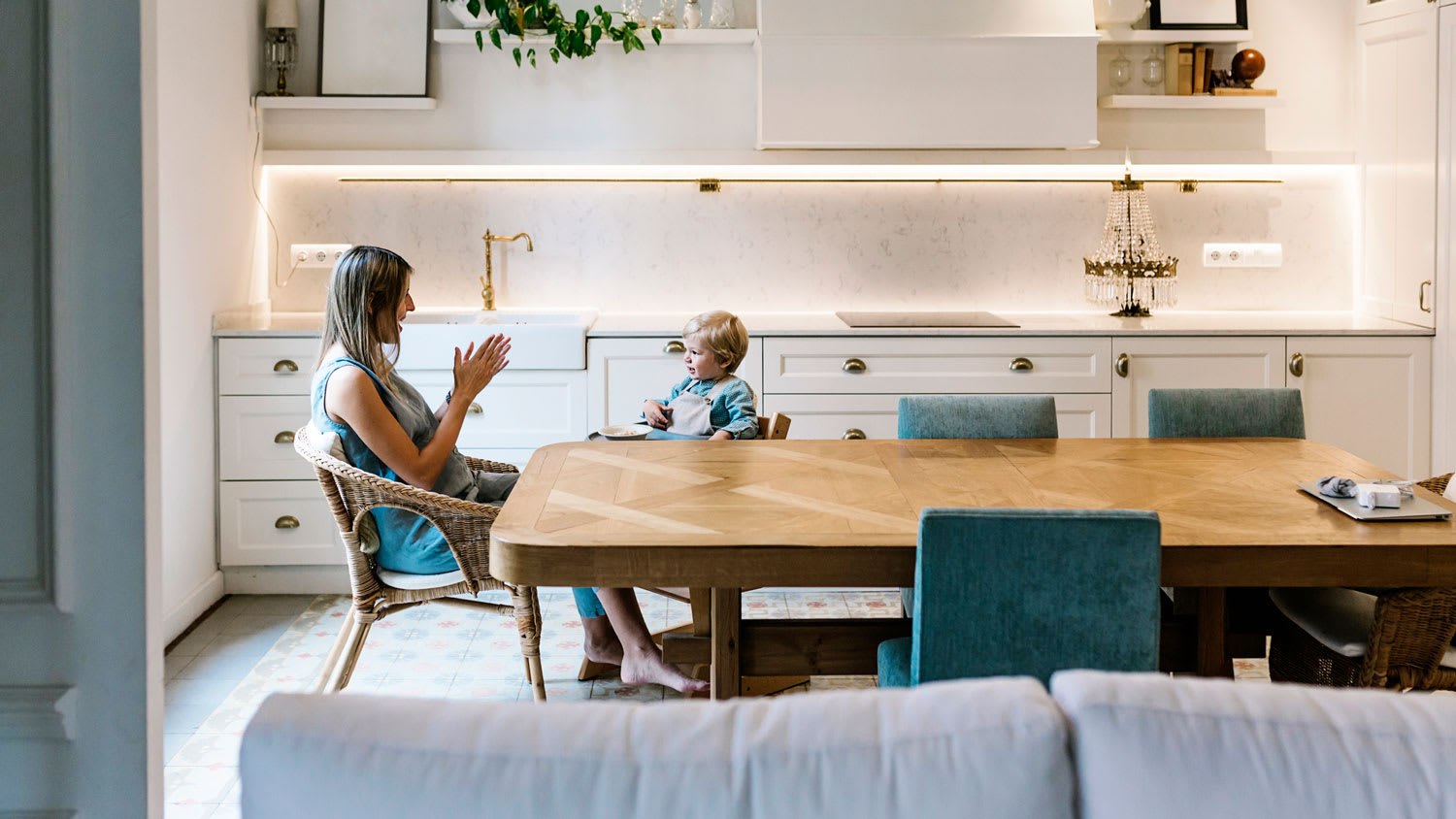 A mother and her son spending time together in the kitchen