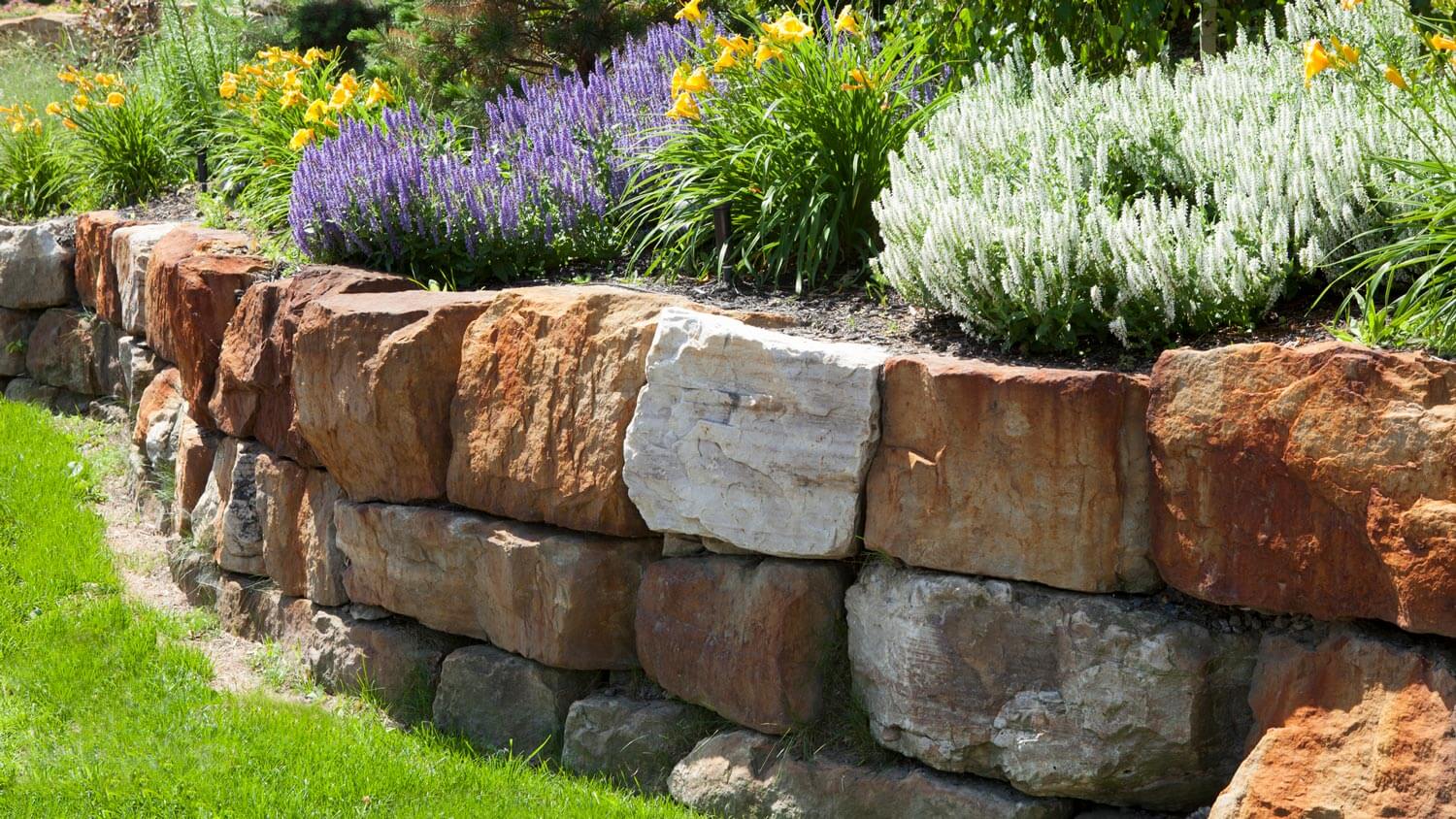 A natural stone retaining wall in a garden