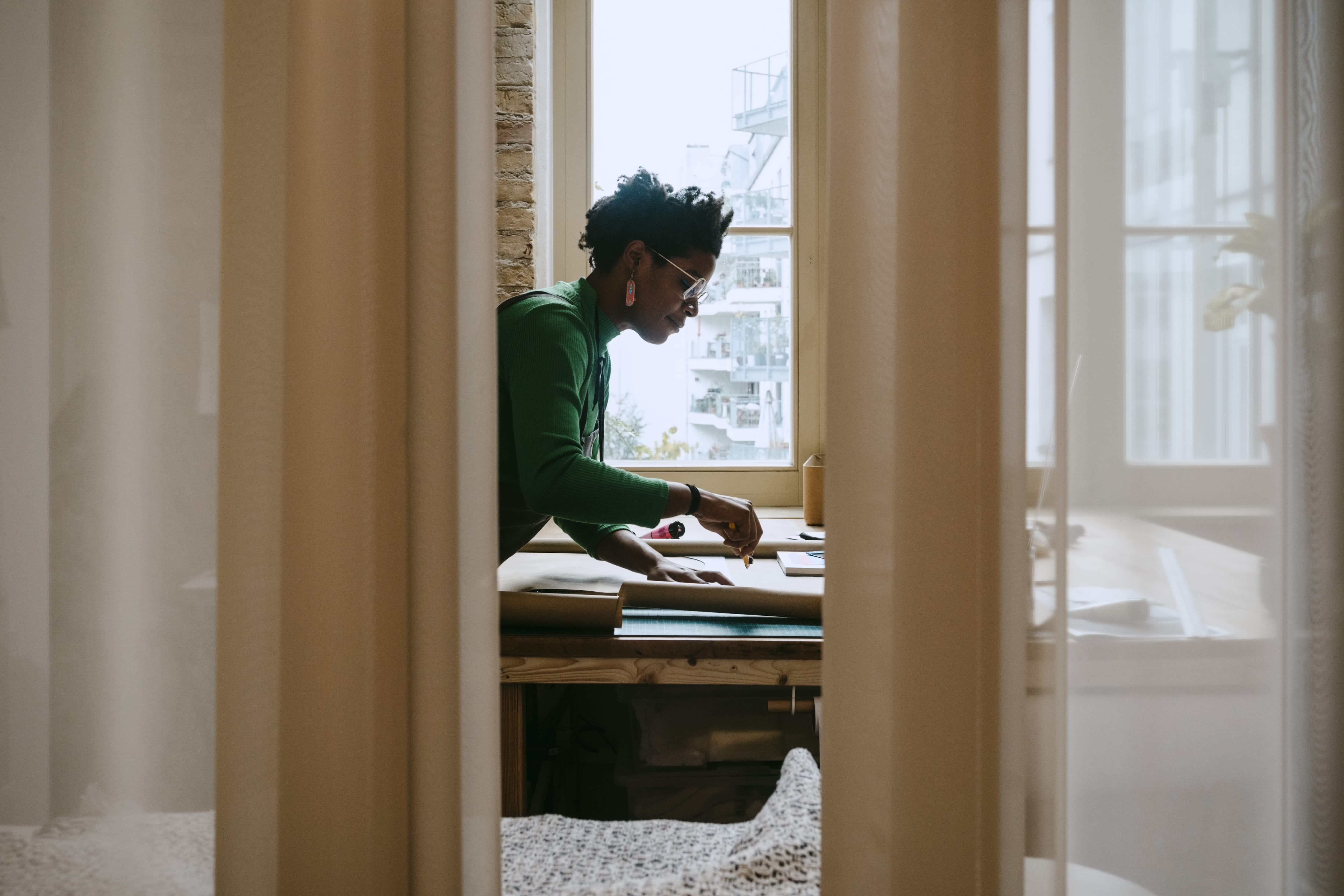 Woman doing work behind room divider