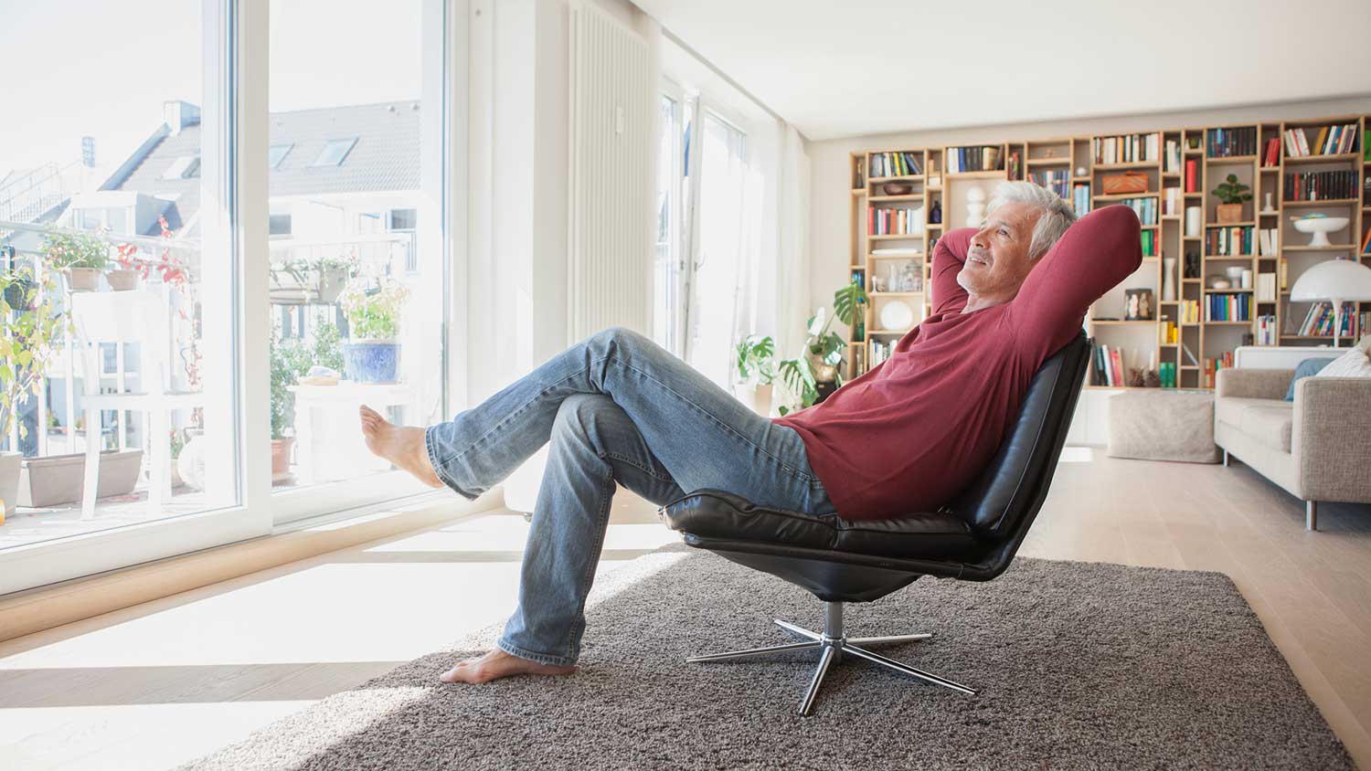 Man sitting on a leather chair relaxing at home