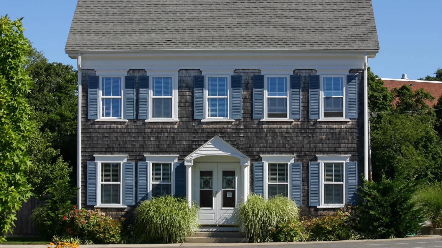 A traditional Cape Cod house with shingle siding