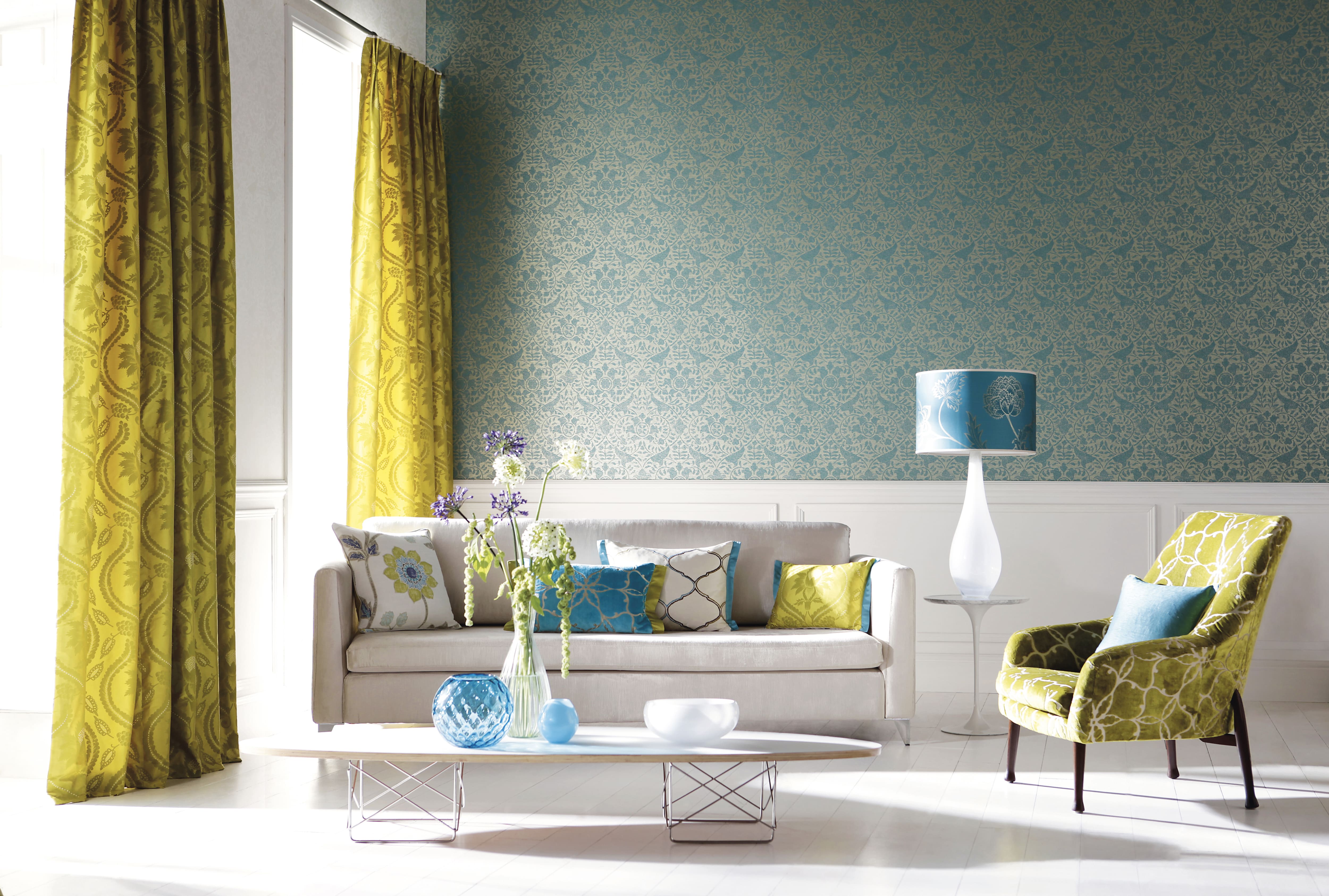 Blue patterned wallpaper and wainscoting accent wall in living room