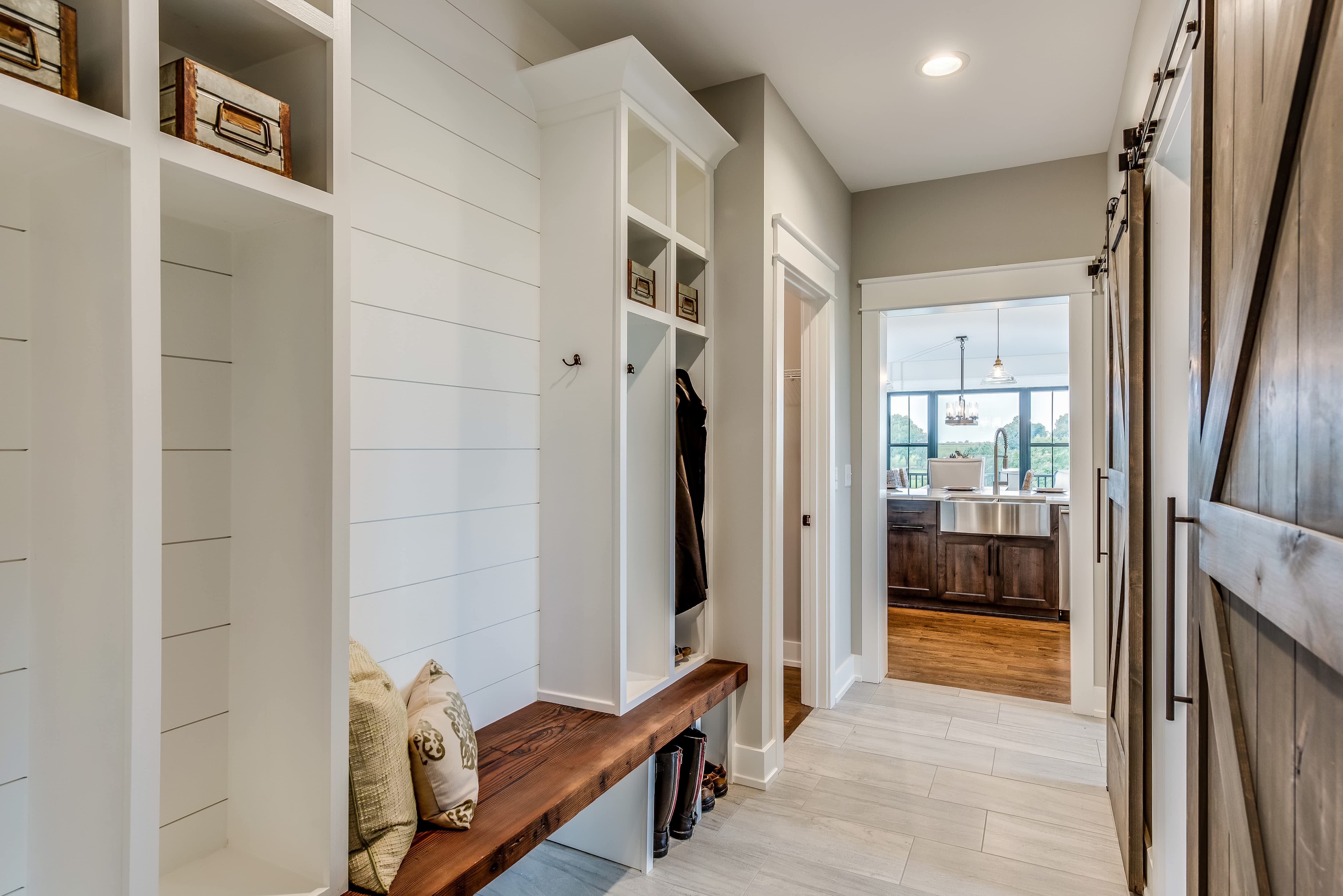 Mudroom with white shiplap wall and wooden bench