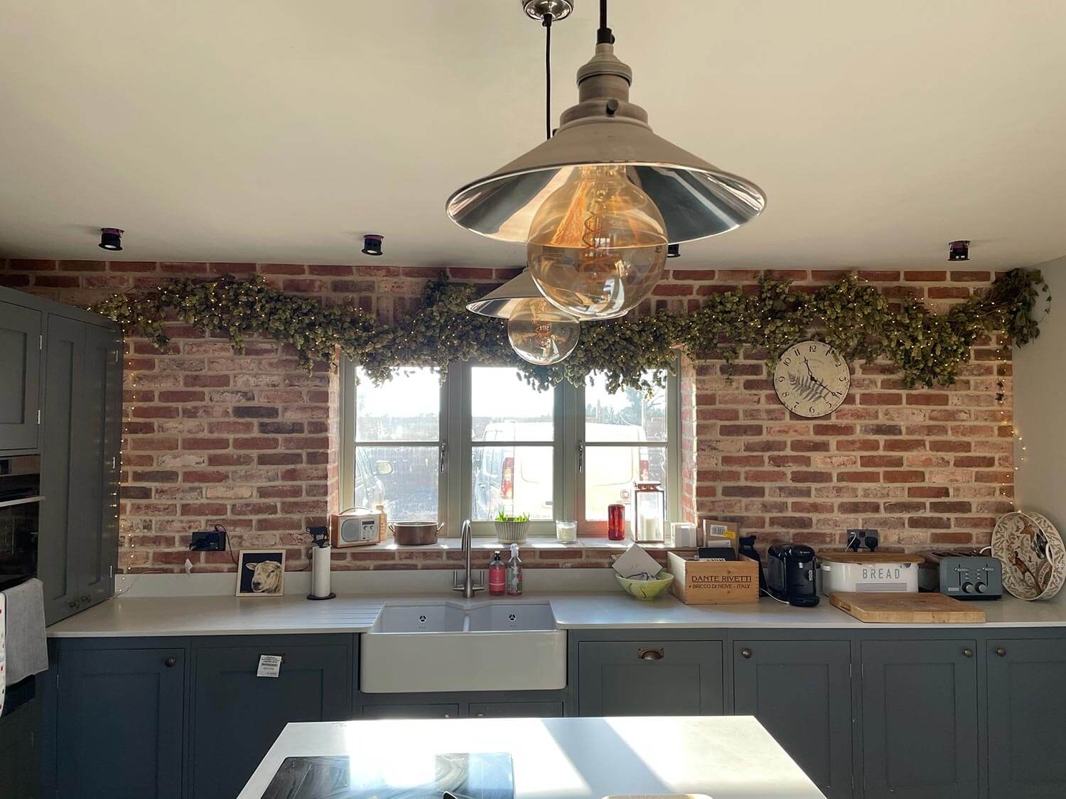 A kitchen with an exposed brick wall