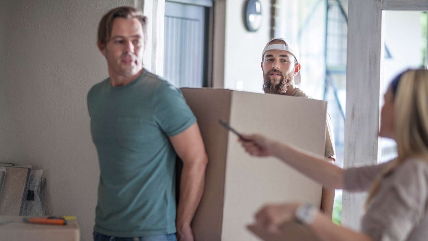 Workers from a moving company carrying boxes