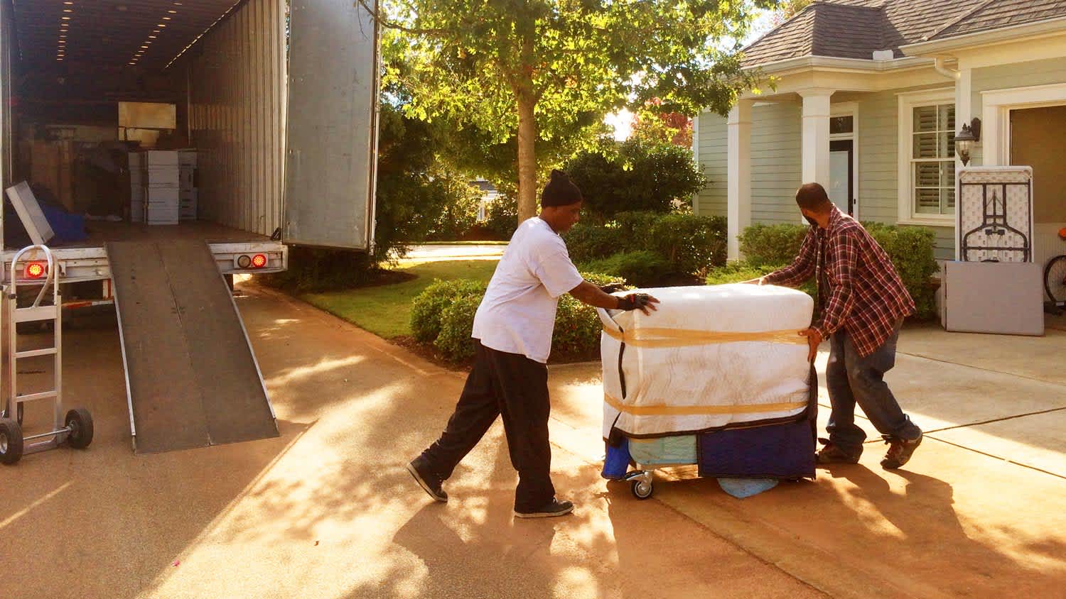 Two professionals moving furniture in the new house