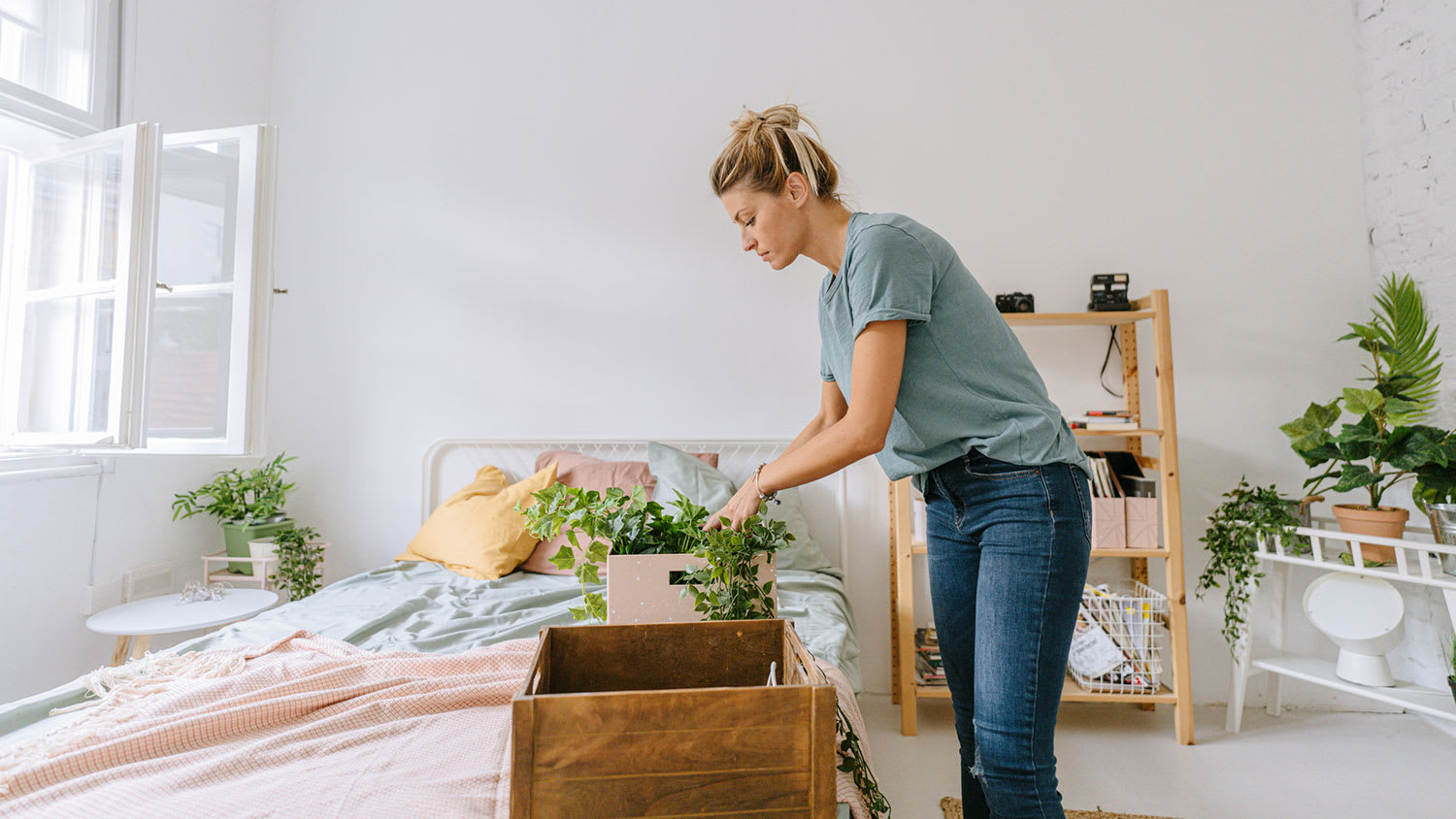 Woman packing bedroom ornaments in a box
