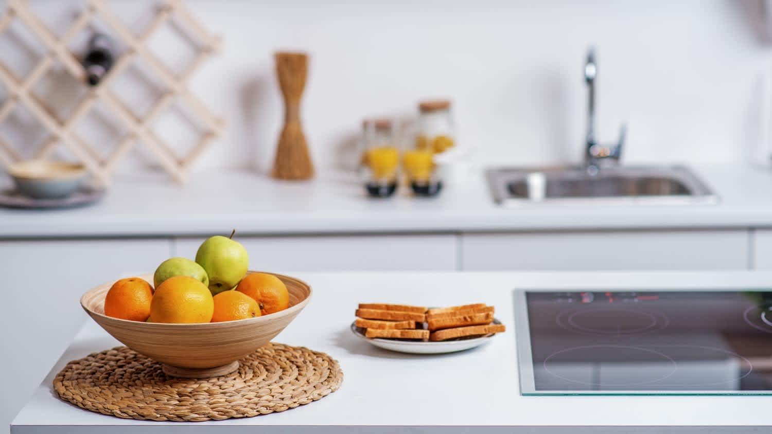 Fruits in plate near electric stove