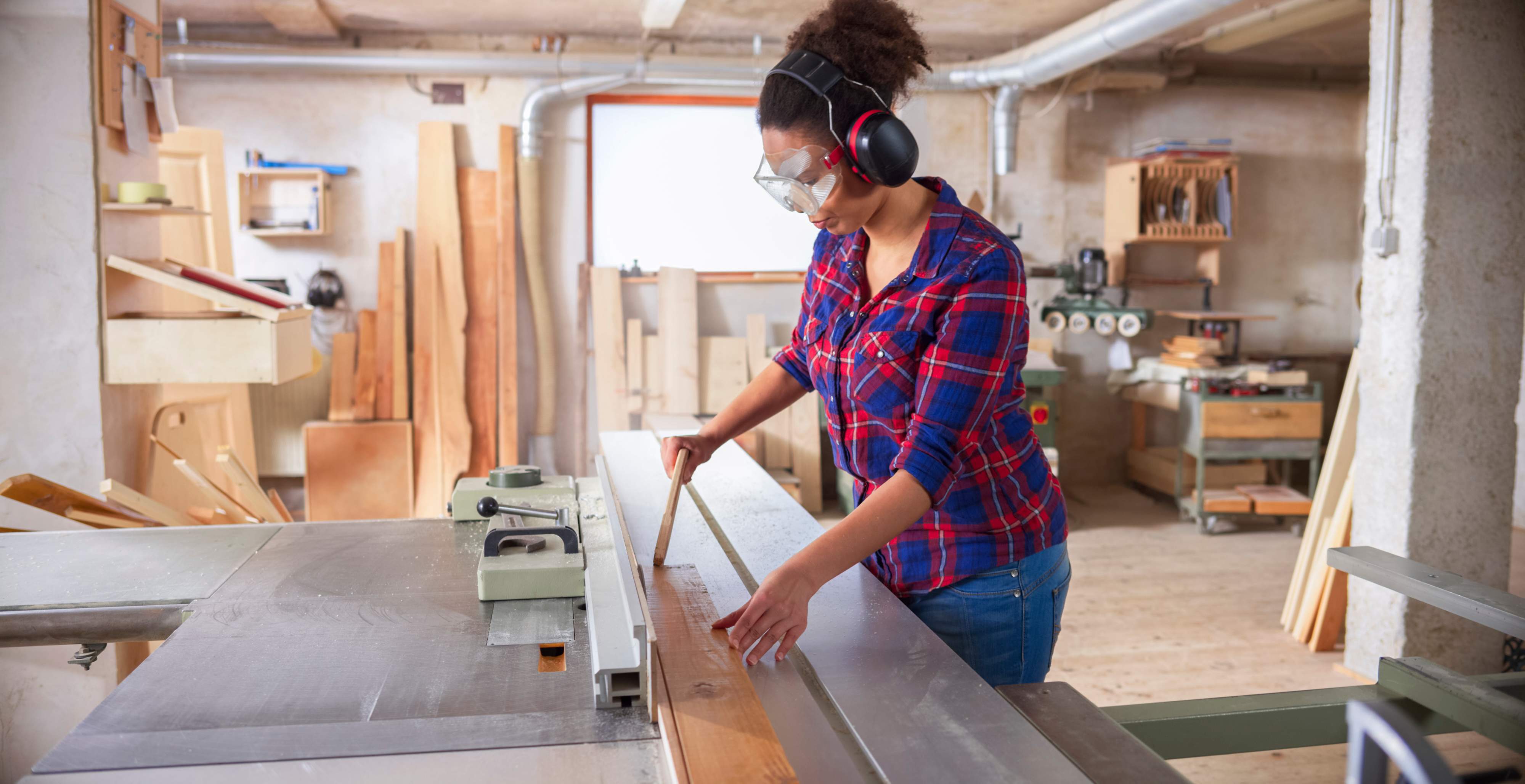 A female construction worker wearing safety glasses
