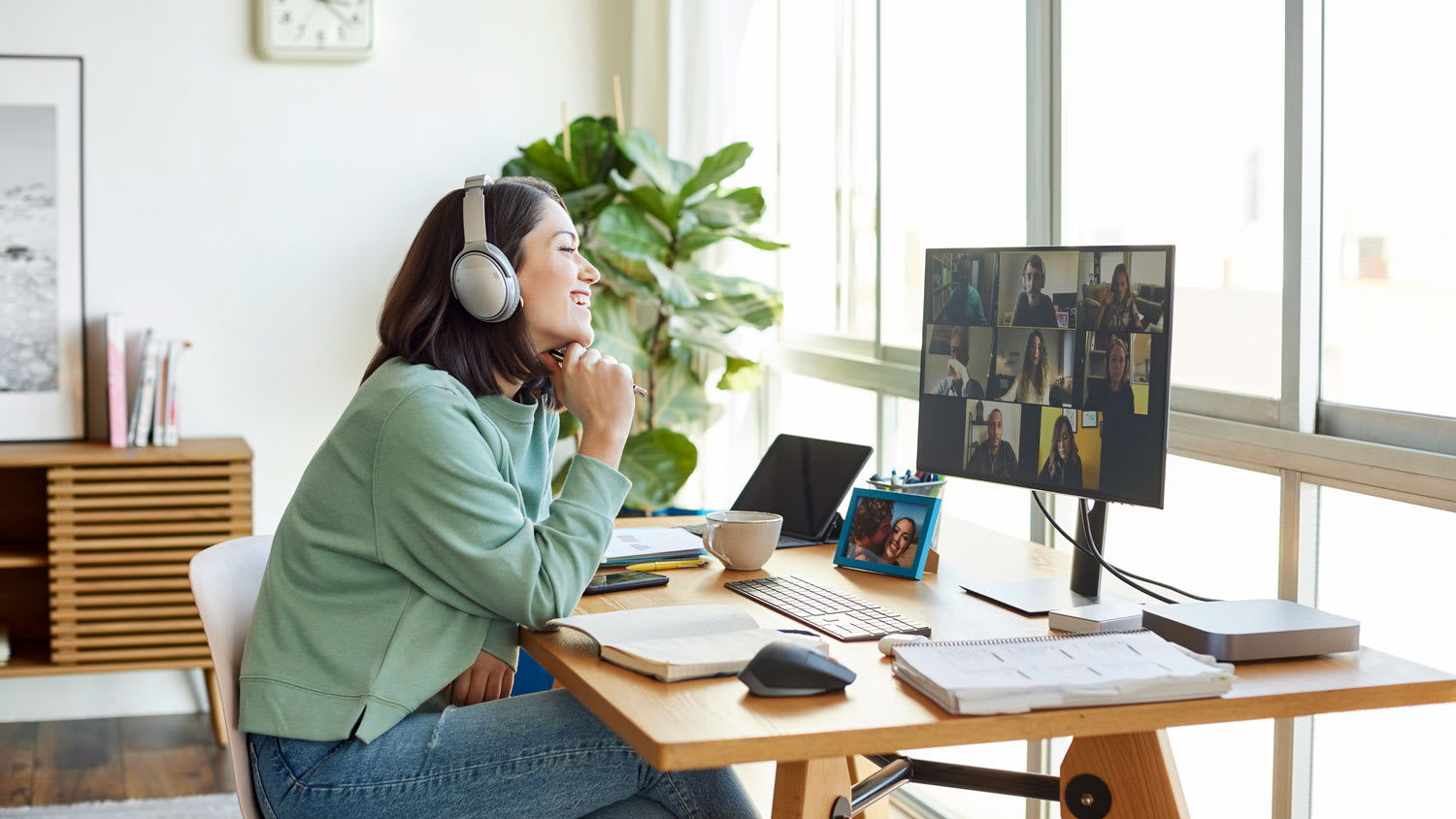 A woman discussing with colleagues over video call