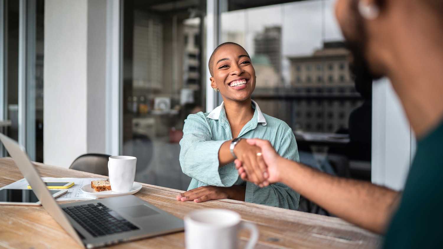 A homeowner shaking hands with the property manager