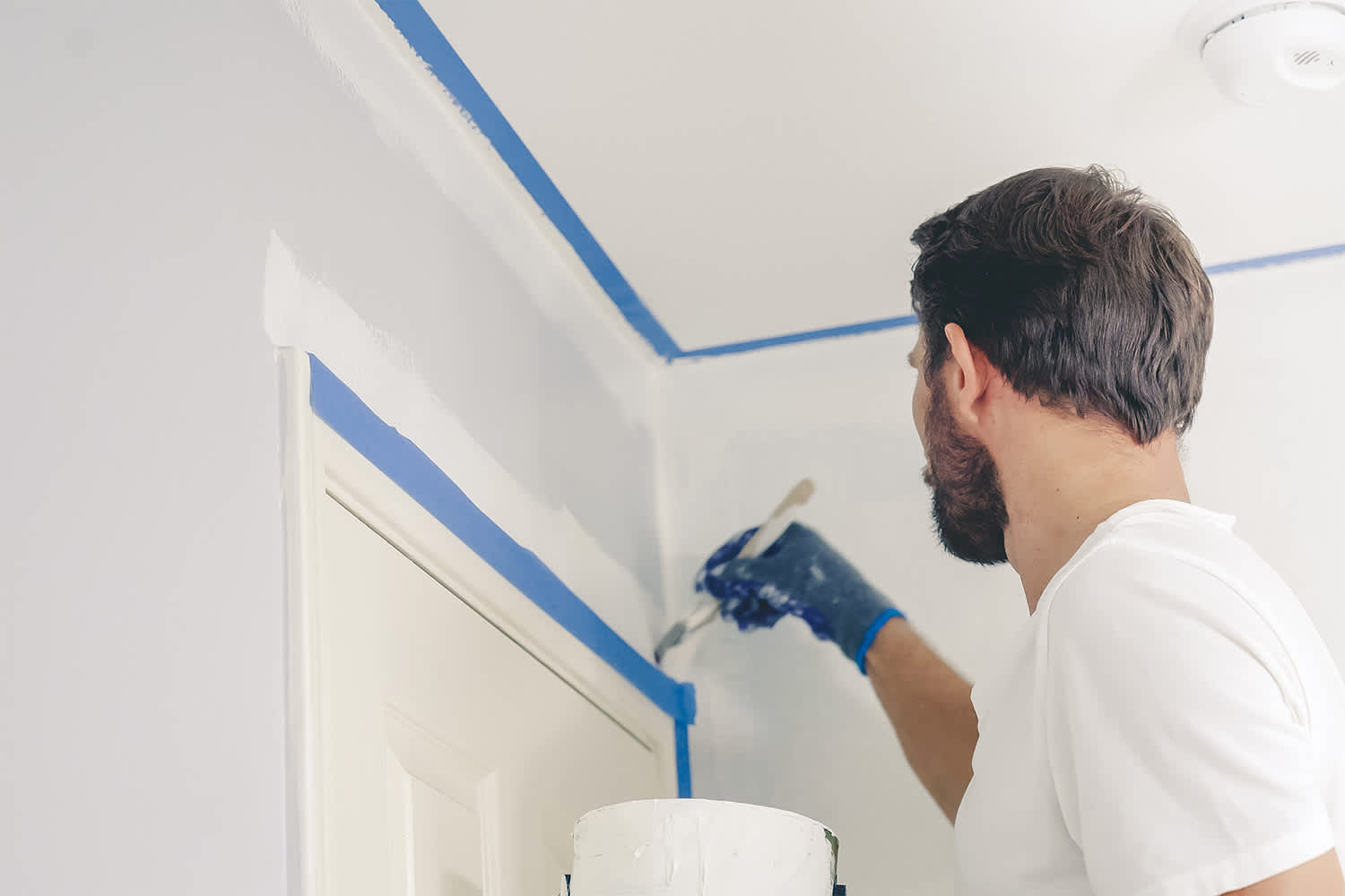 Professional painter painting interior wall