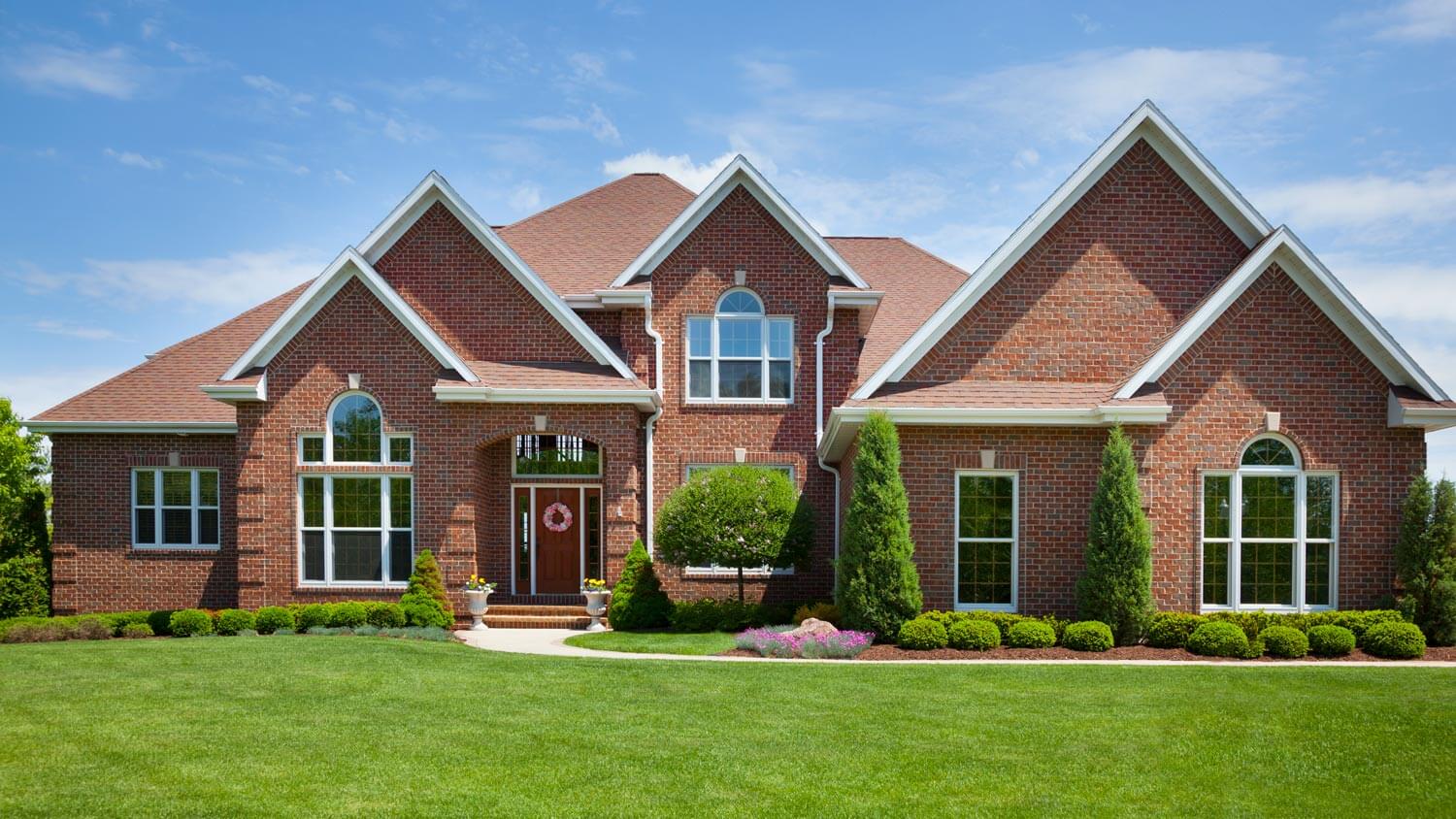 A brick home with perfect lawn