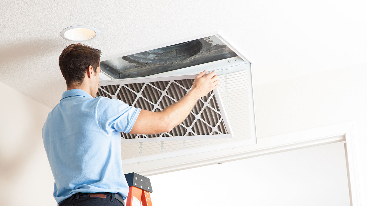 Man opening air duct cover